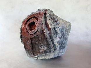 Mixed media object cast from waste materials focal point is an area of red flocking